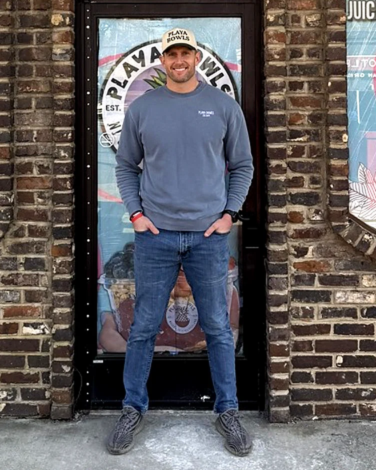 Henry Anderson, owner of Playa Bowls Tennessee, standing in front of his Knoxville shop